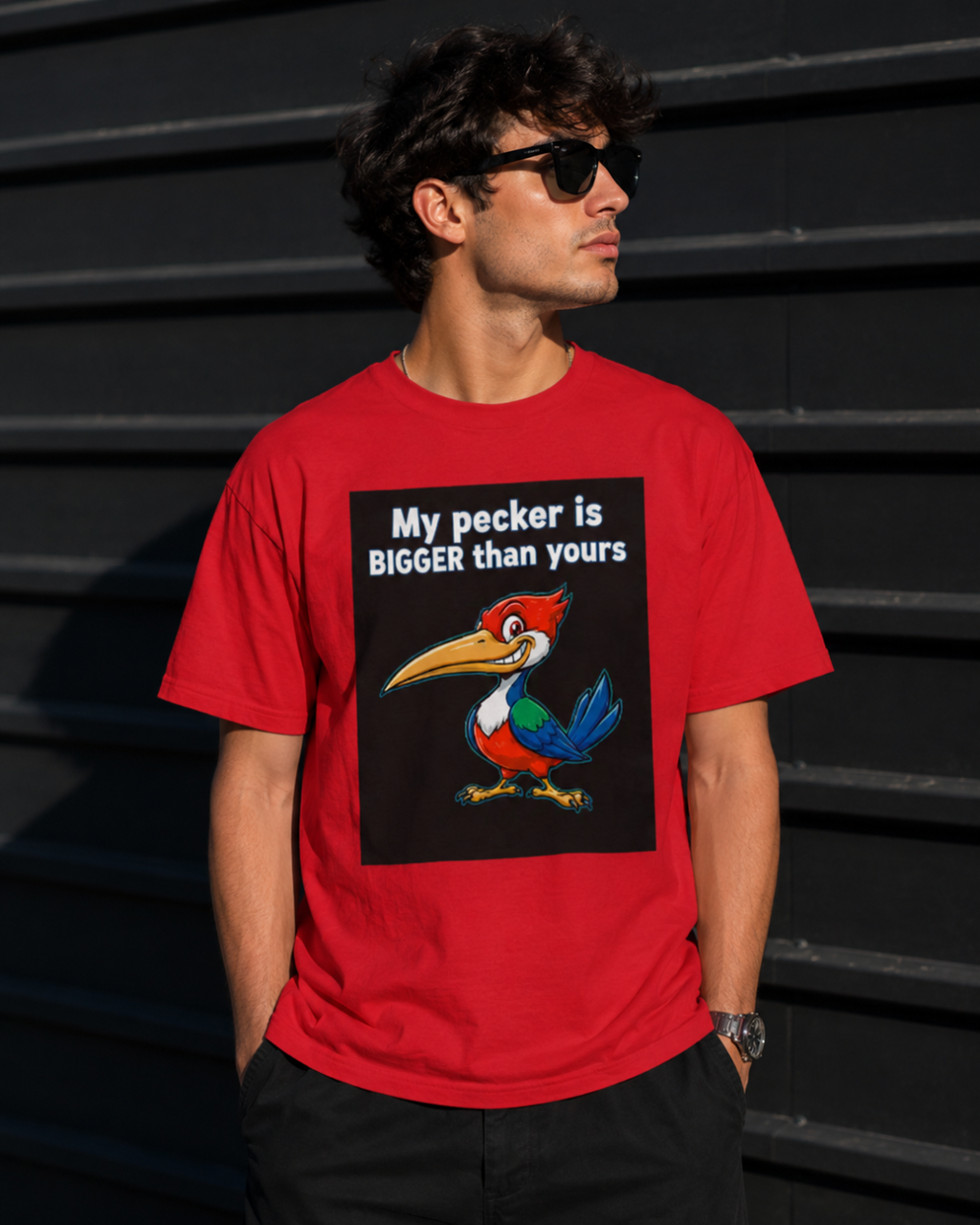 Man wearing a red t-shirt with a graphic and text against a dark background